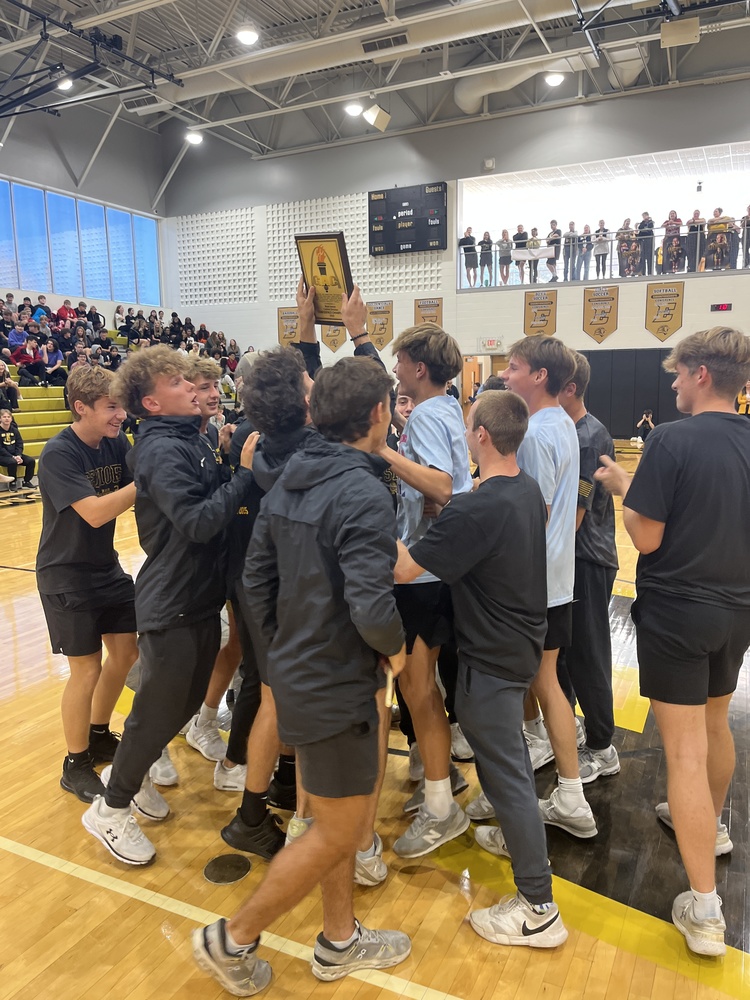 Boys soccer celebrating their trophy presentation