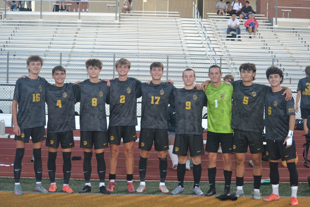 Lions Soccer players posing in their military jerseys