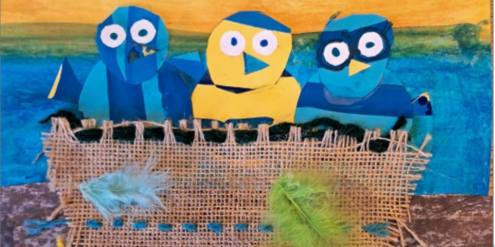 Blue and Yellow birds stare out of a burlap nest stitched with yarn and a pop of blue and green feathers