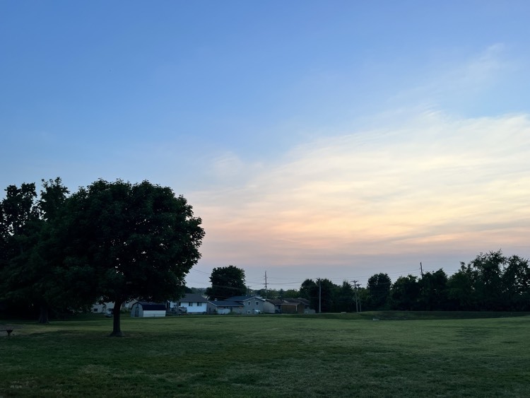 a sunset - orange light on blue sky