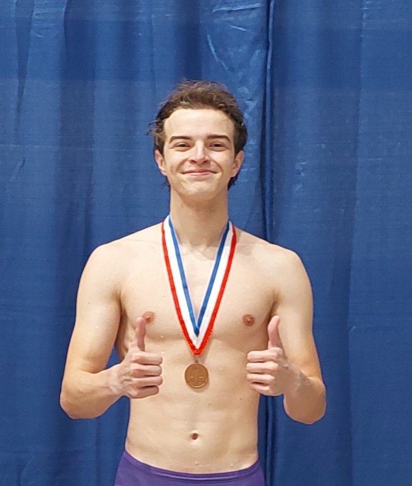Austin Bates posing with his medal