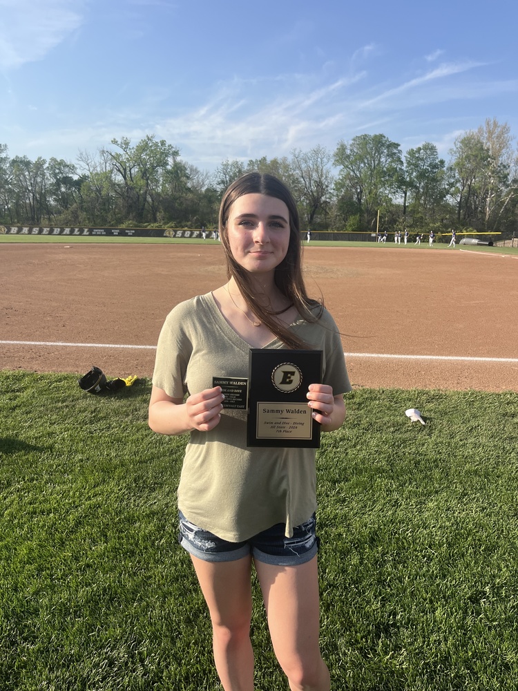 Sammy Walden holding her all state and record breaker plaque