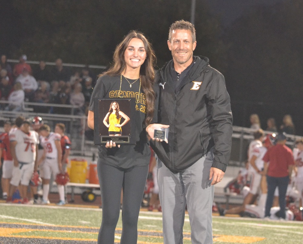 Avery Foster and Mr. Wilber posing at half field