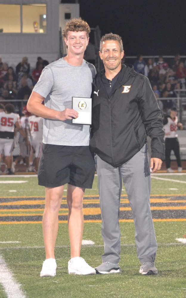 Carson Topping and Mr. Wilber posing at half field