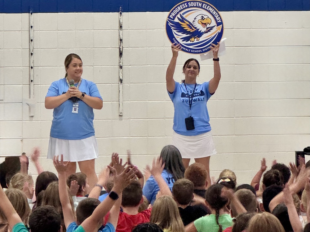 Two teachers leading an assembly