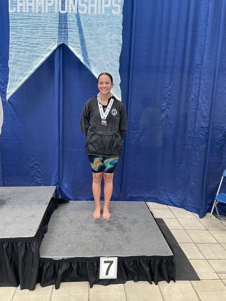 Maya West standing on the state 7th place podium