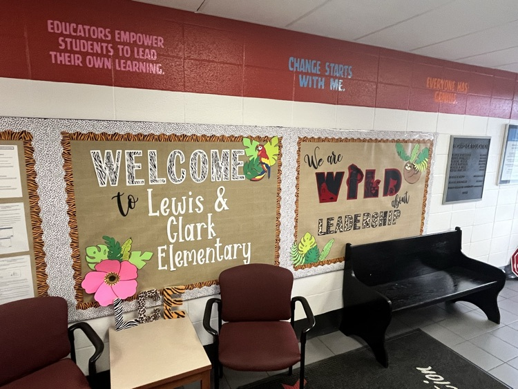 LCE Vestibule! Red paint at top of wall, bulletin boards in middle, chairs and benches.