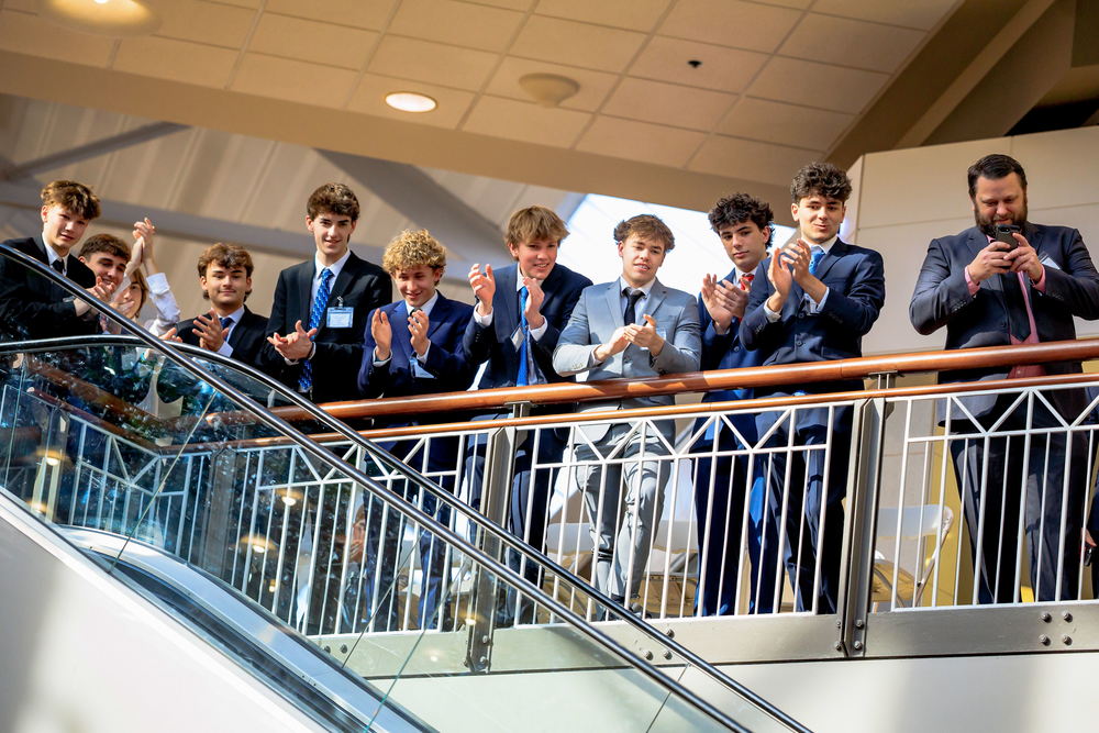 Our DECA team celebrating a win on the balcony of the district stage
