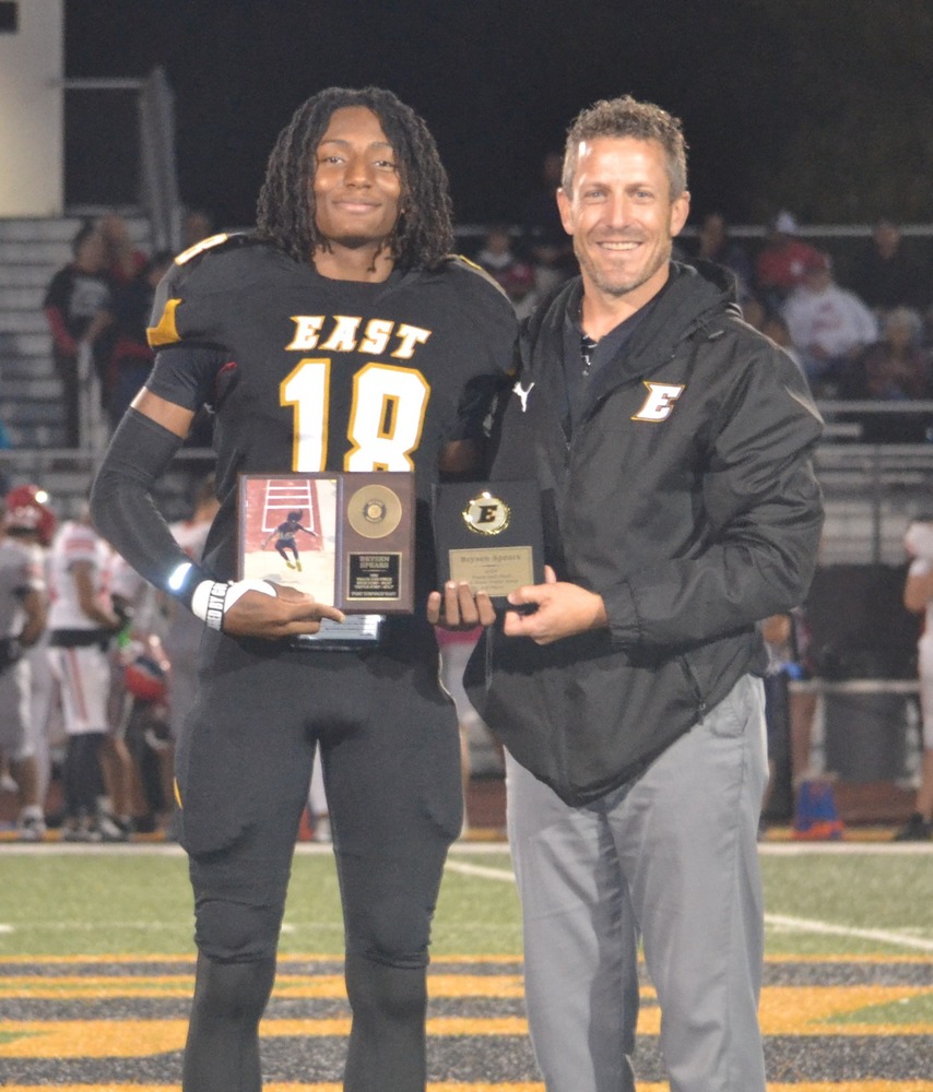 Brysen Spears and Mr. Wilber posing at half field