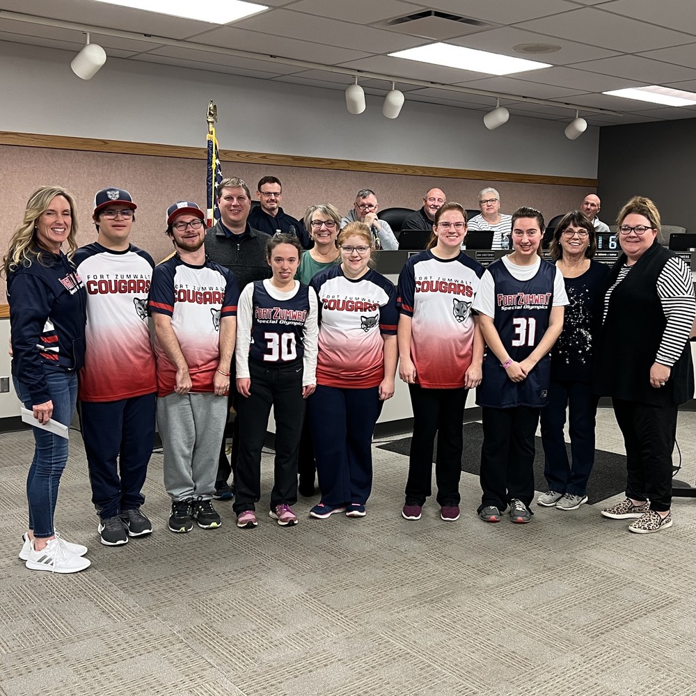 Special Olympics softball team poses with Board President