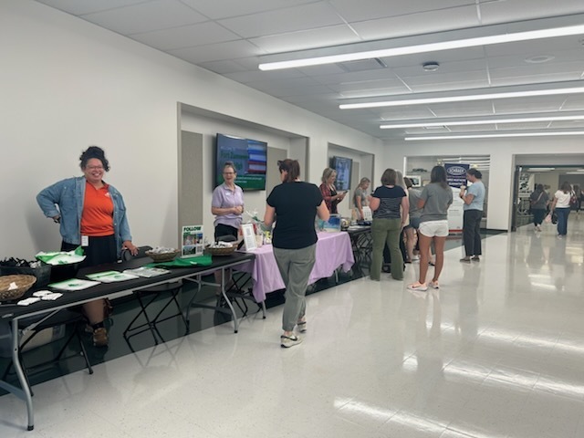 Business leaders greet teachers in the foyer