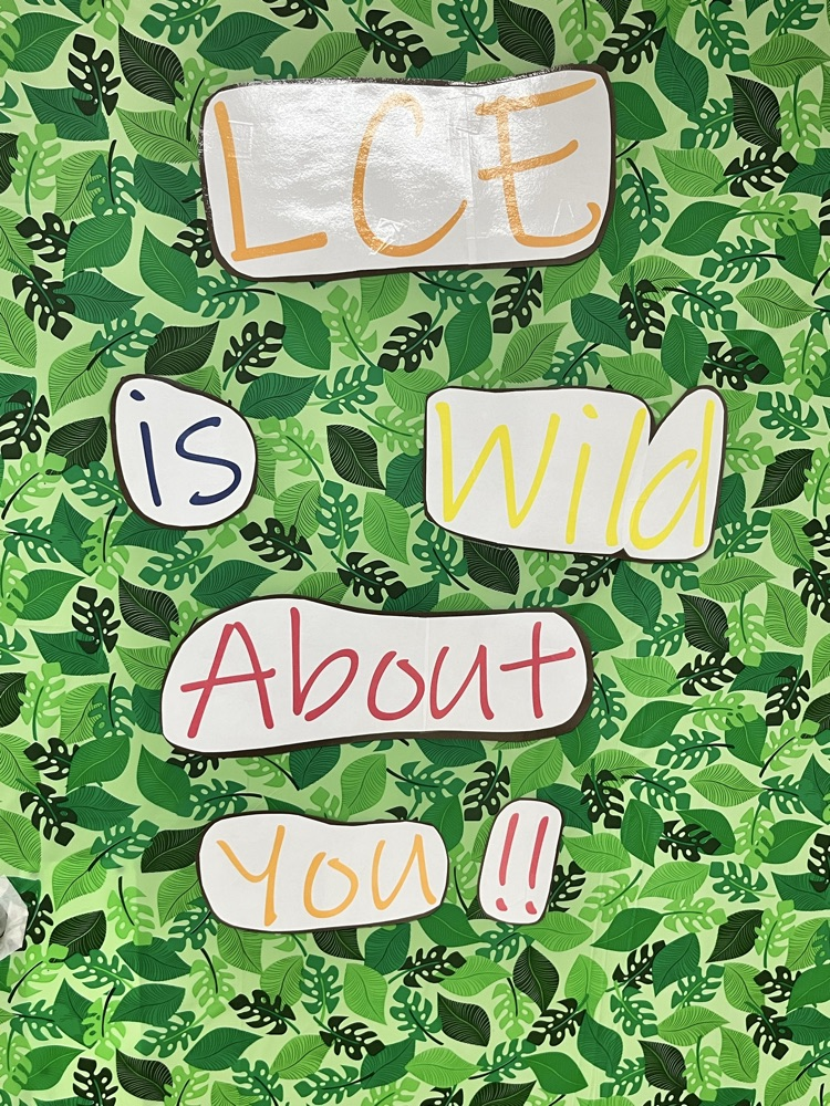 Green leaf print sign reads LCE IS WILD ABOUT YOU