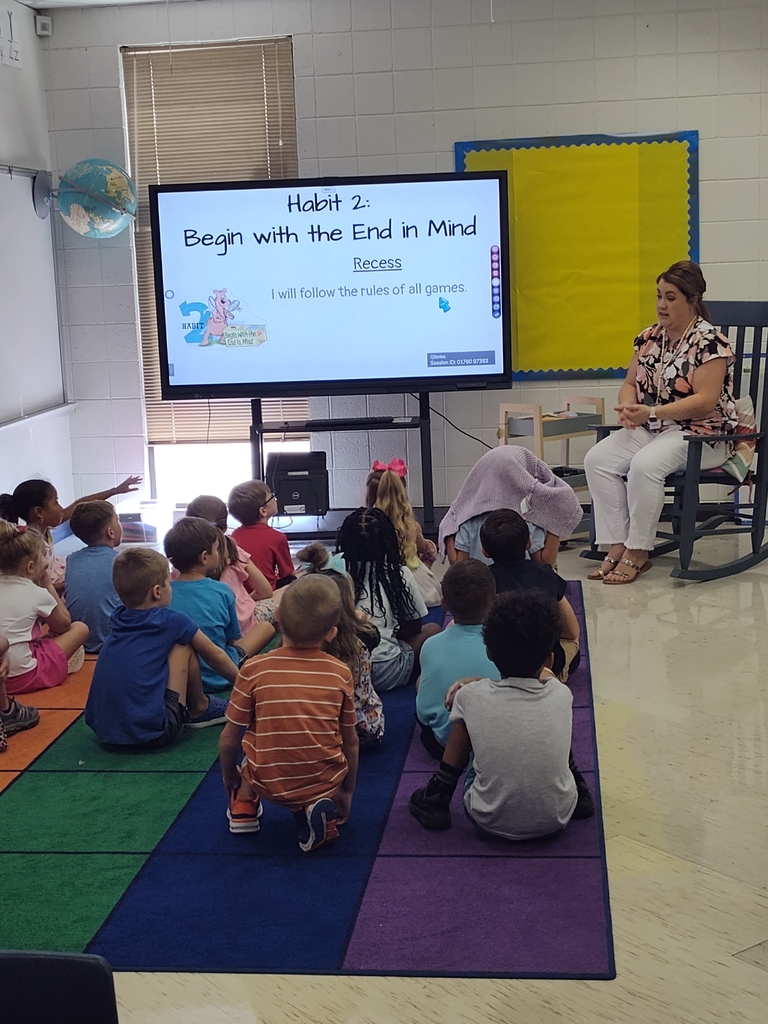 Students face an interactive TV while the teacher goes over expectations and aligns them to the 7 habits of Leader in Me.