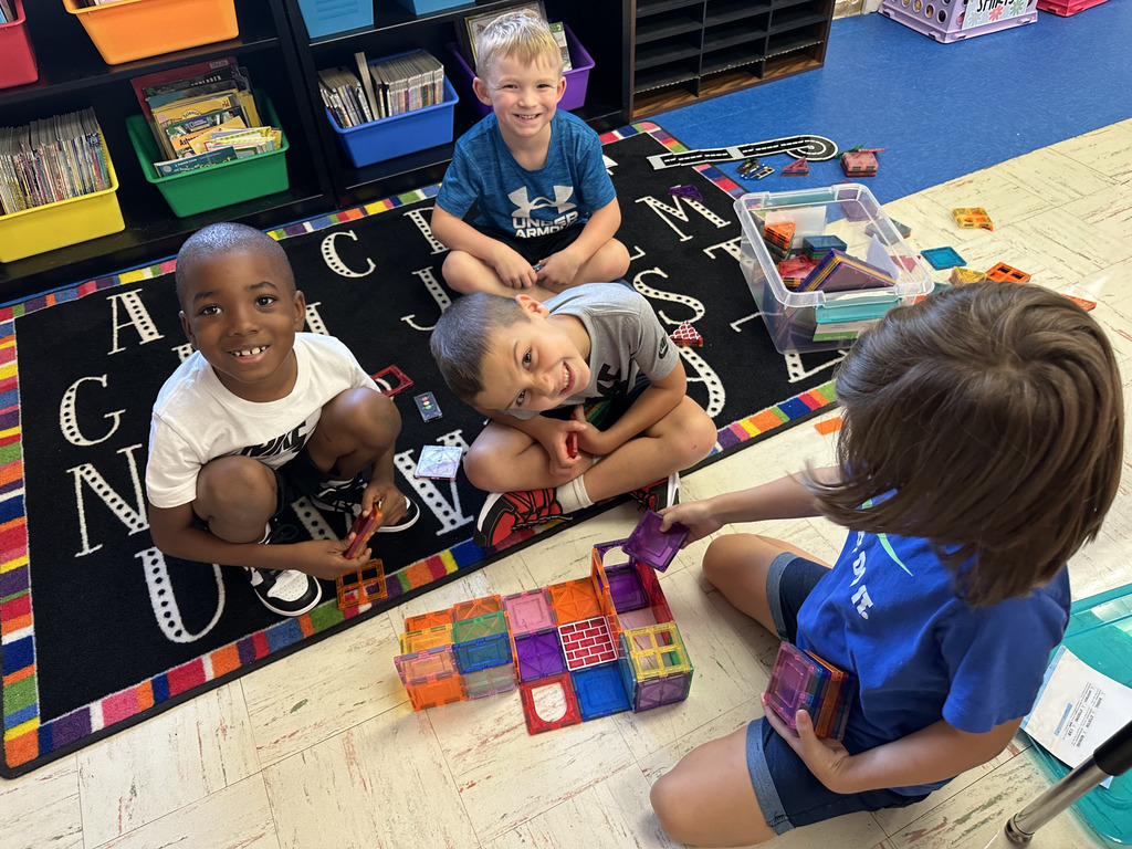 1st grade students working with building blocks
