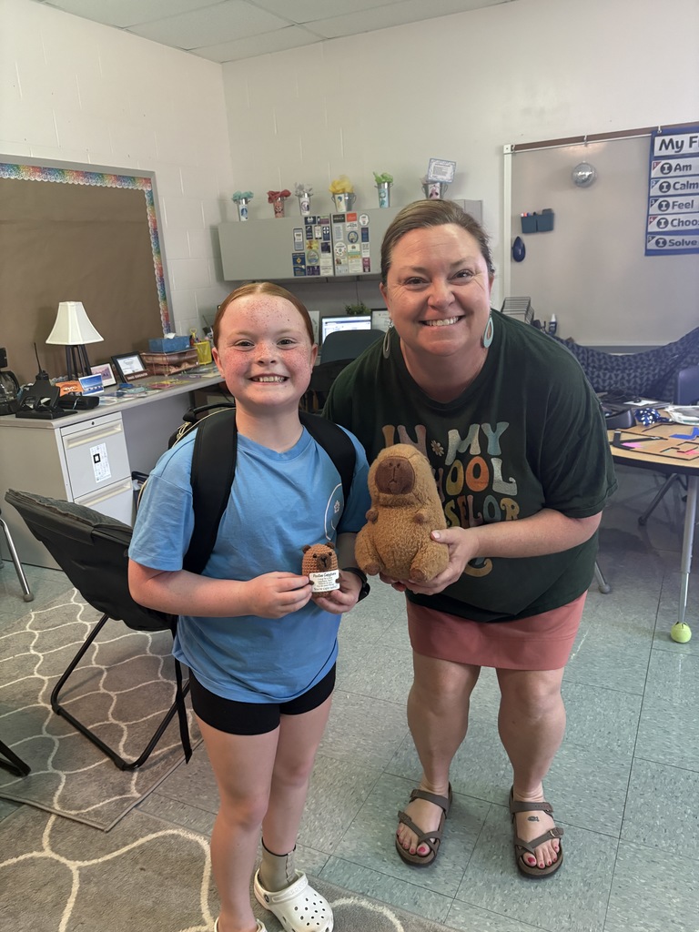Mrs. Mullins with a 5th-grade student