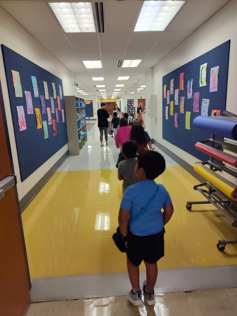 students walk down the hallway in a line