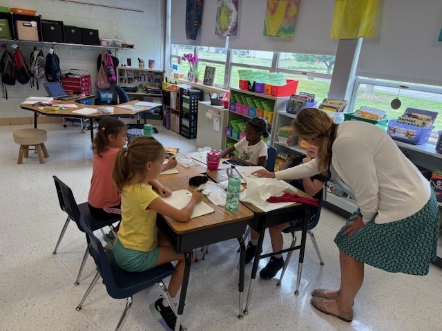 Ms. Zeier working with students as they played their math centers.