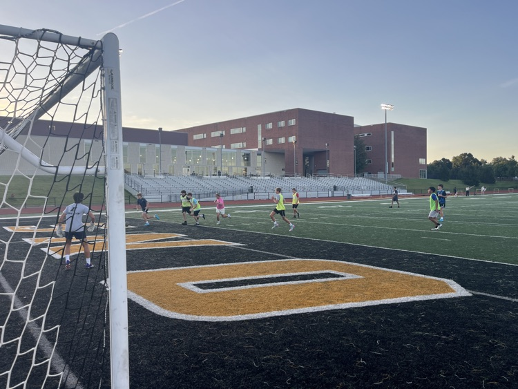 C soccer practicing on the stadium field