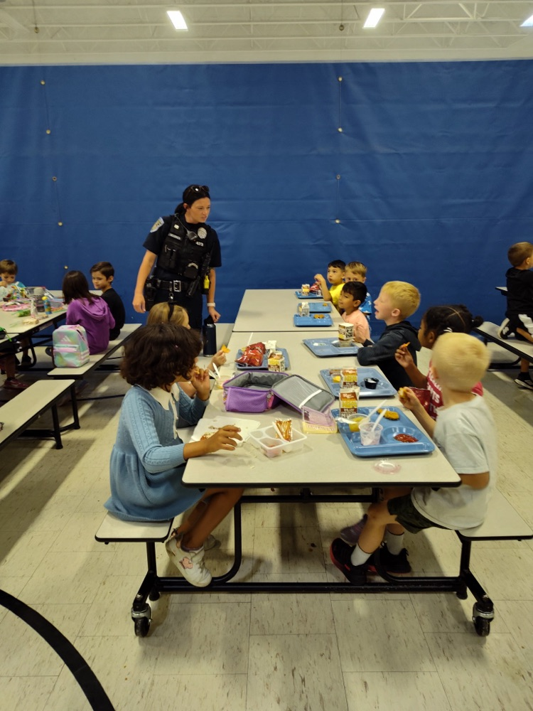 Police officer helping in the cafeteria