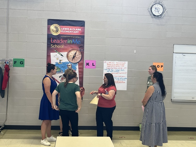 teachers meeting and discussing math standards