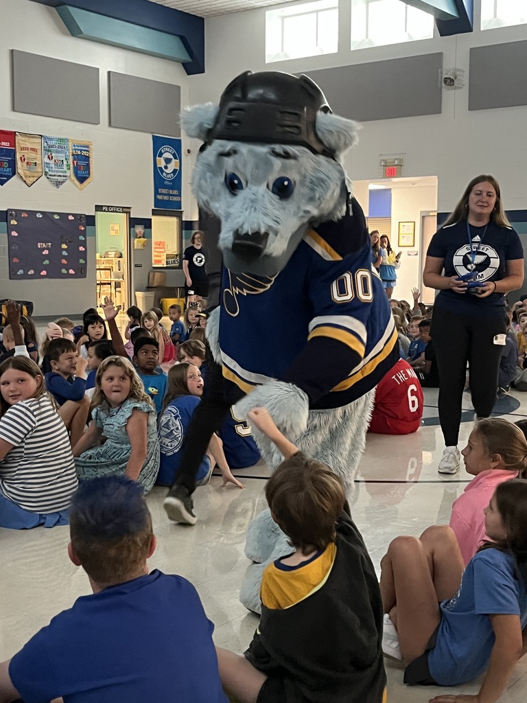 Louie high fives a student