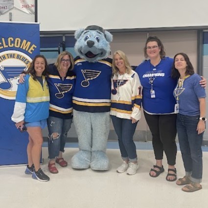 Teachers pose with Louie in their StL Blues gear