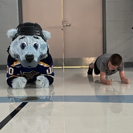 Louie and a student in a push-up contest