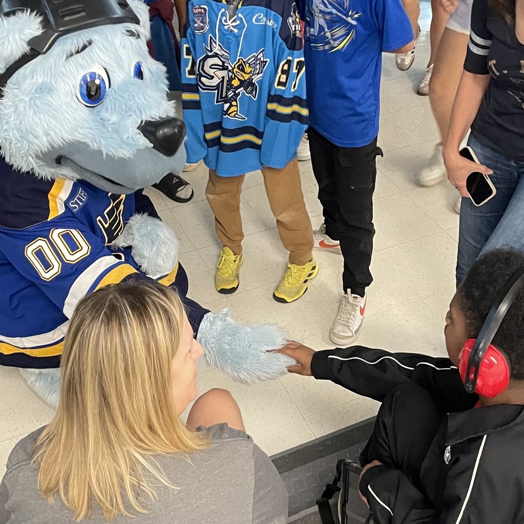 Louie takes time out to meet some of the students on the bleachers