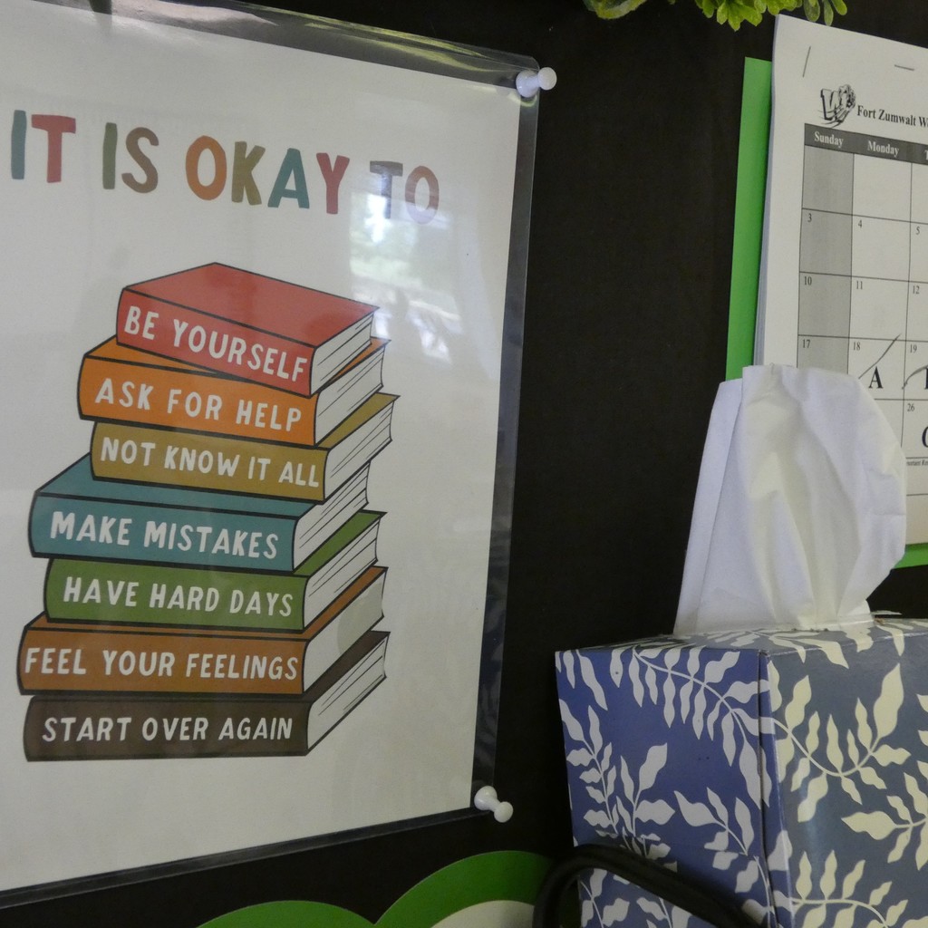 Poster inside classroom door next to a box of Kleenex reminds students it is OK to be yourself, ask for help, not know iit all, make mistakes,  have hard days, feel your feelings, start over again