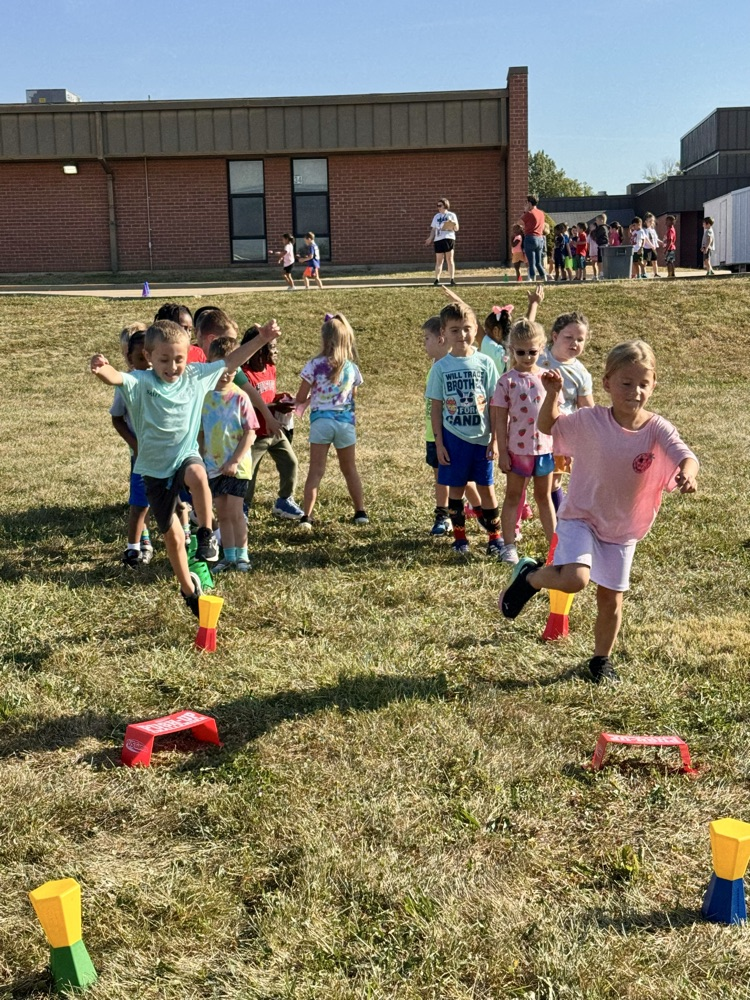 A class relay race jumping over objects for “Jack Be Nimble."