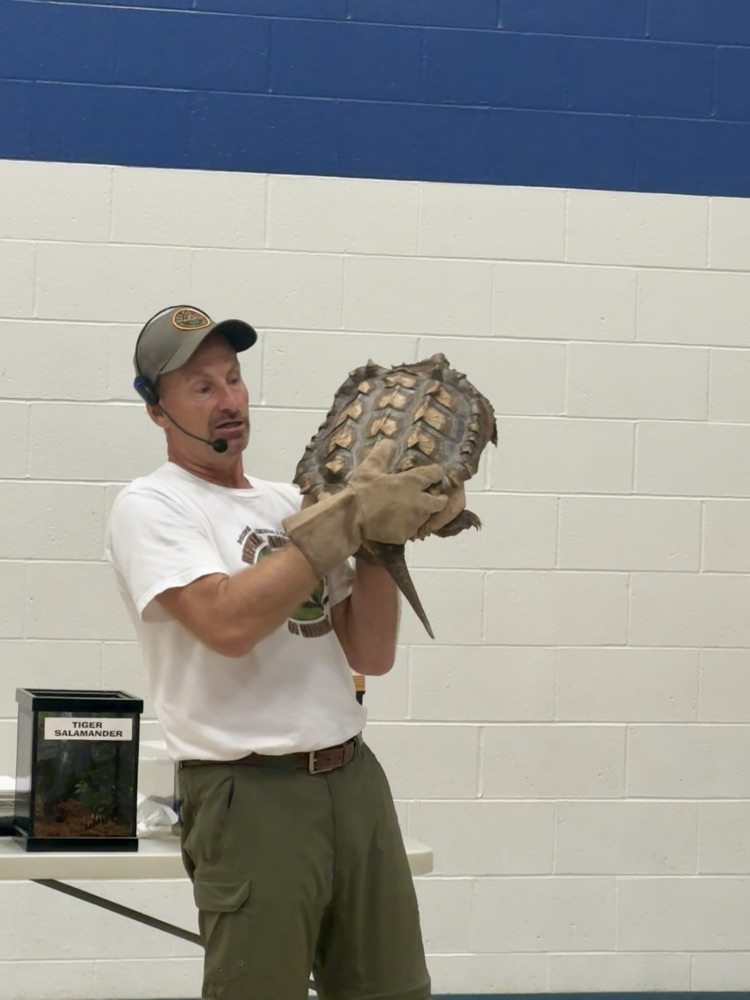 Man holding snapping turtle 