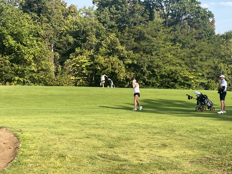 Lily hitting approach shot