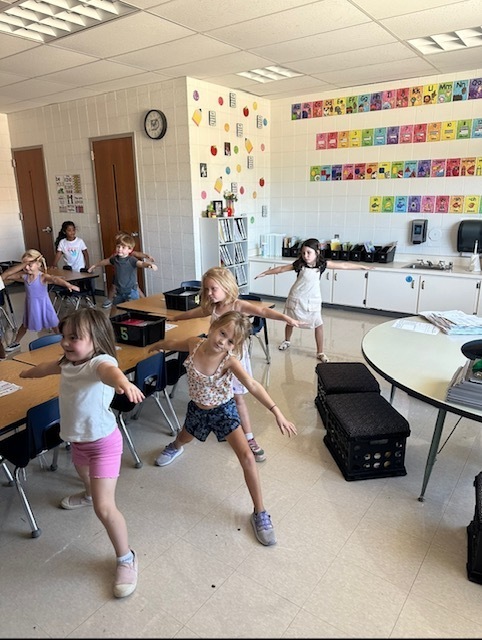 Students practicing a warrior yoga pose