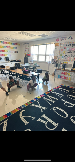Students practicing a squatting yoga pose