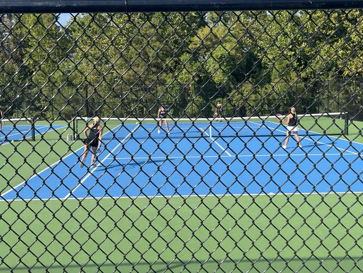Smith sister doubles team receiving serve