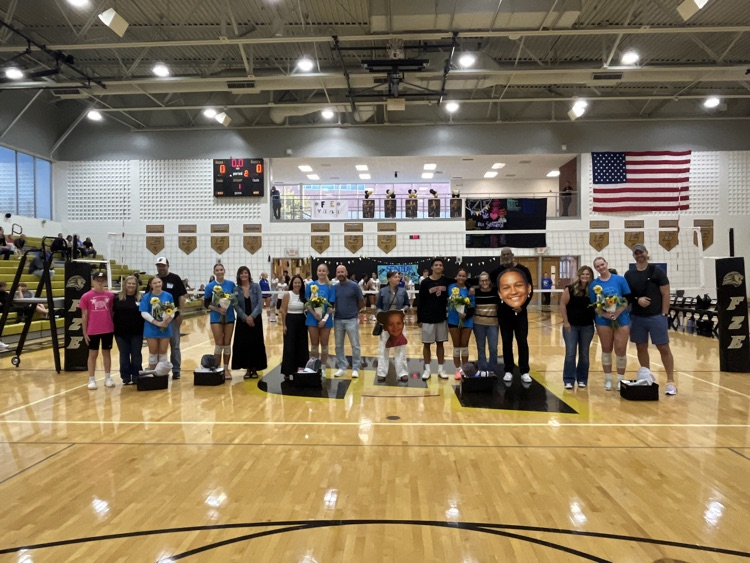 Seniors posing for a photo in front of the net