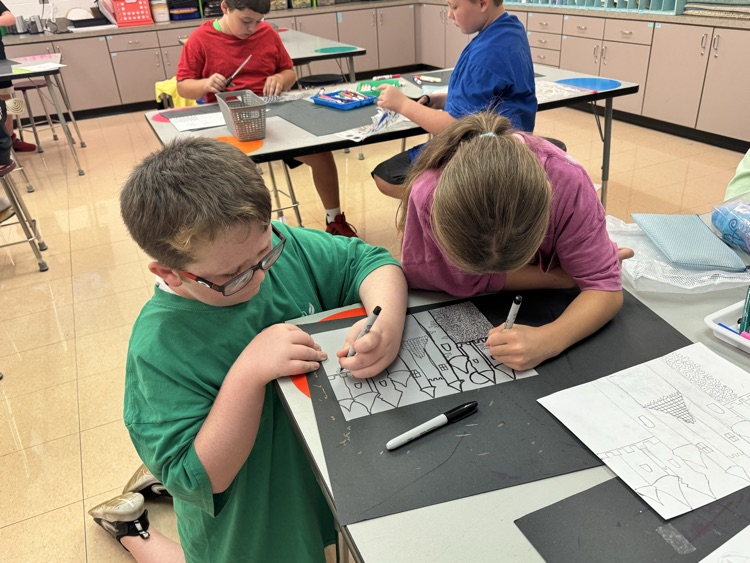 two fourth graders decorating a castle together