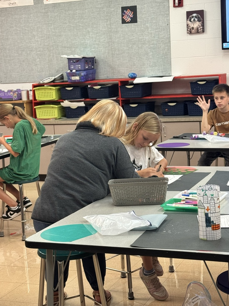 Ms. Sellmeyer working with a student one on one on their castle