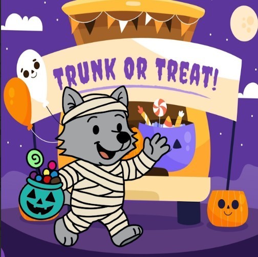 Mid Rivers Wolf in a mummy costume with a bucket of candy and a sign that says, Trunk or Treat.