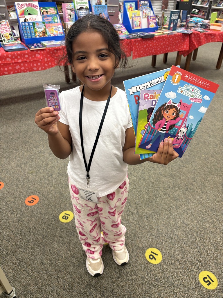Brooklyn with her book choices from her $20 shopping spree!