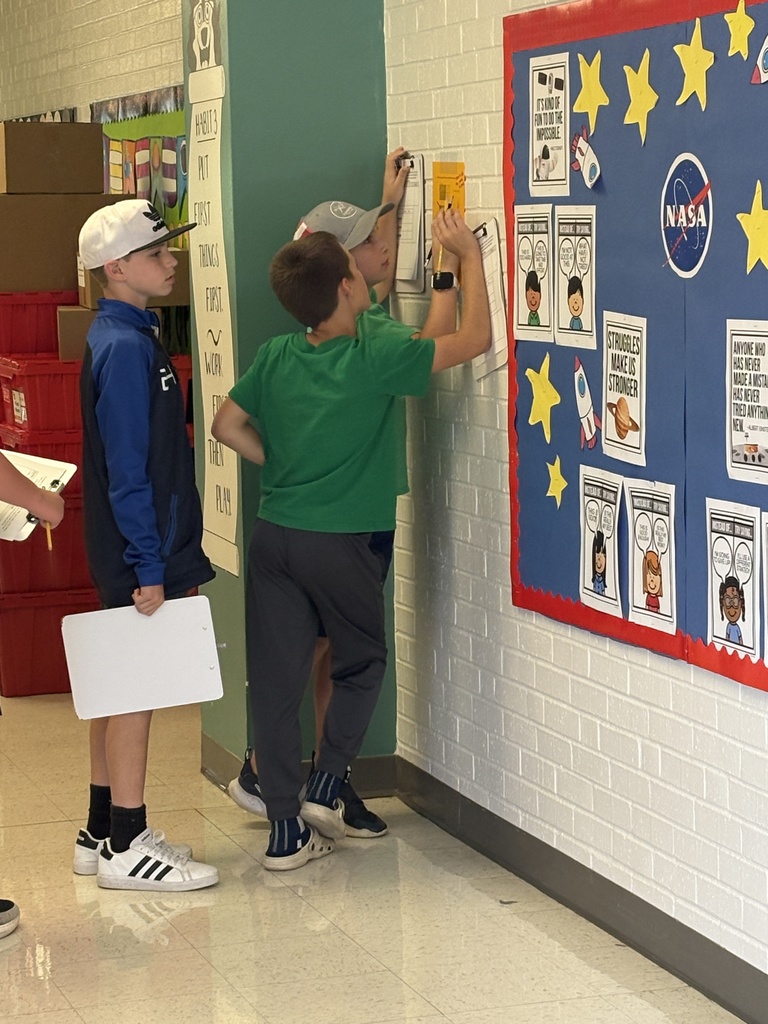 Three 5th-grade students working together to solve math problems 