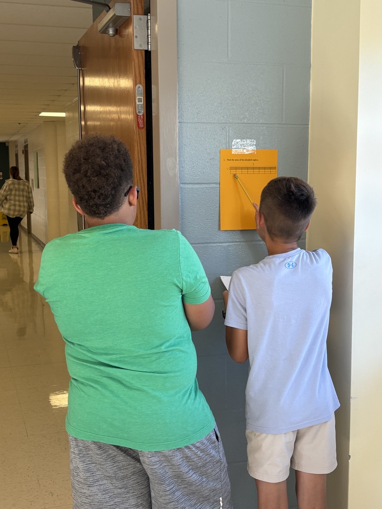 2 5th-grade students working together to solve math problems 