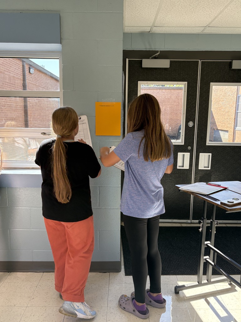Two 5th-grade students working together to solve math problems 