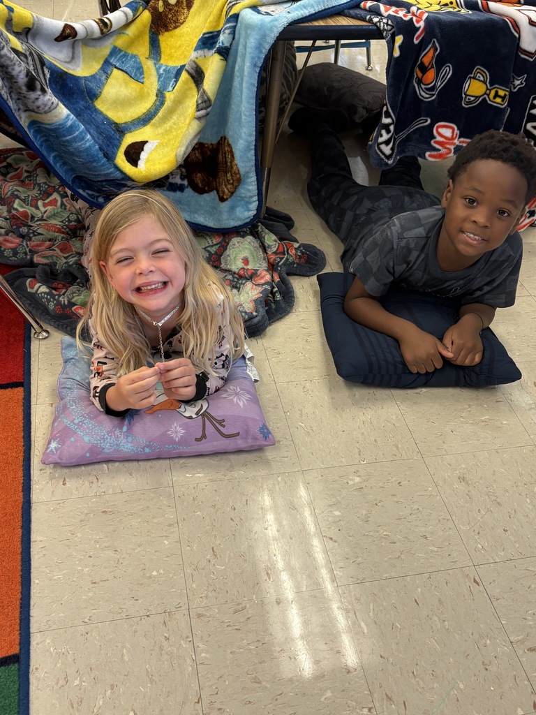 Two 1st-grade students relaxing on their pillows 