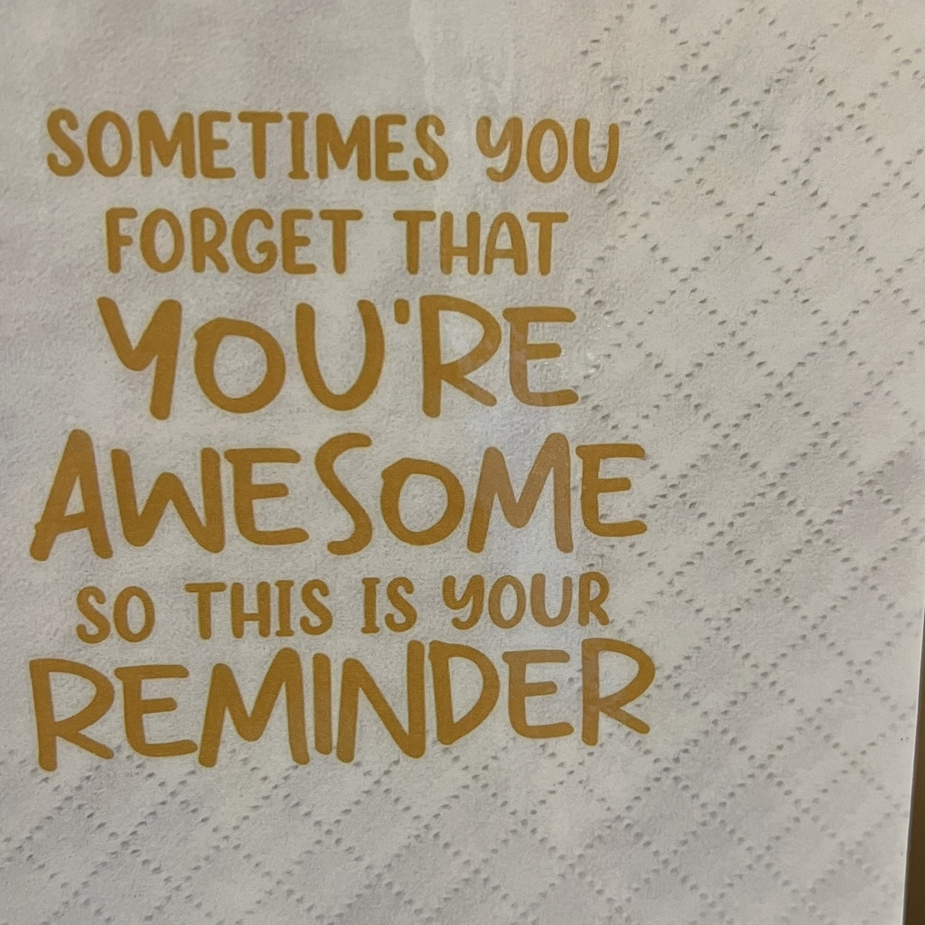 Napkin taped up in bathroom says: "Sometimes you forget that you're awesome so this is your reminder"