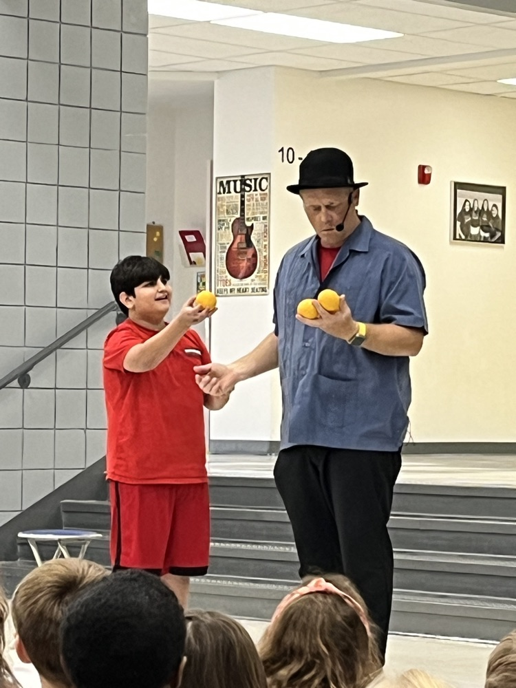 magician juggling with student volunteer