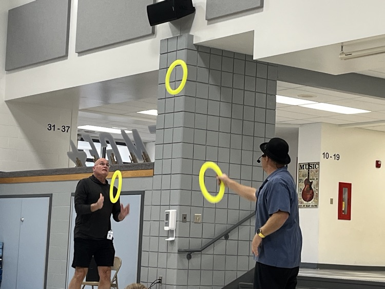 magician juggling with staff volunteer