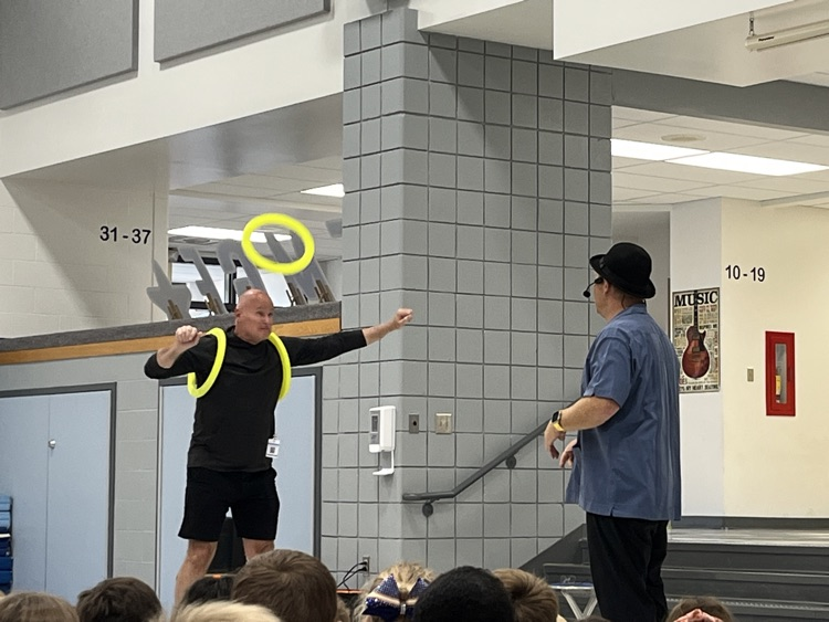 magician juggling with staff volunteer
