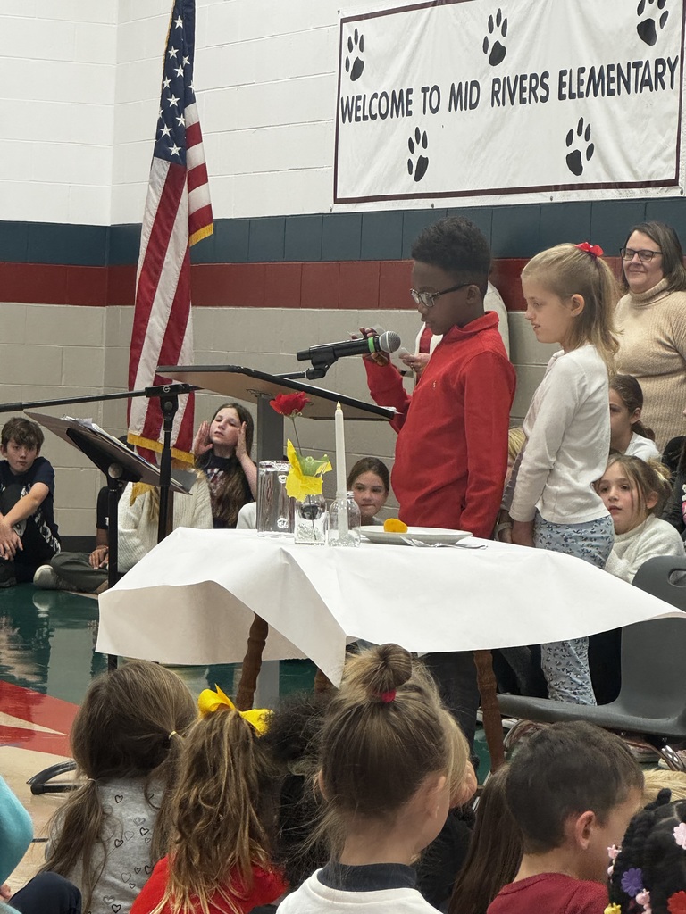 A student leader reading the White Table ceremony.
