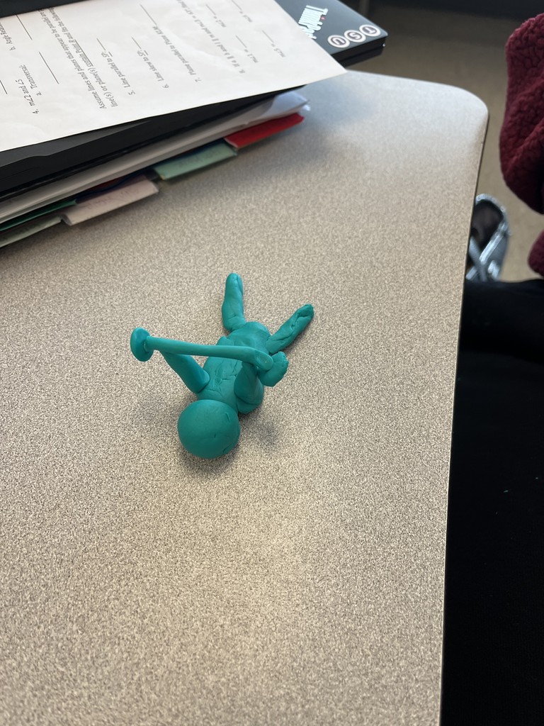 A figure of a person laying down lifting a barbell created in the Math PLC to build connection and learn a creative student engagement activity.